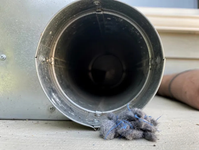 Farmington Dryer Vent Cleaning technician using specialized equipment to clear severe dryer vent blockage in Farmington